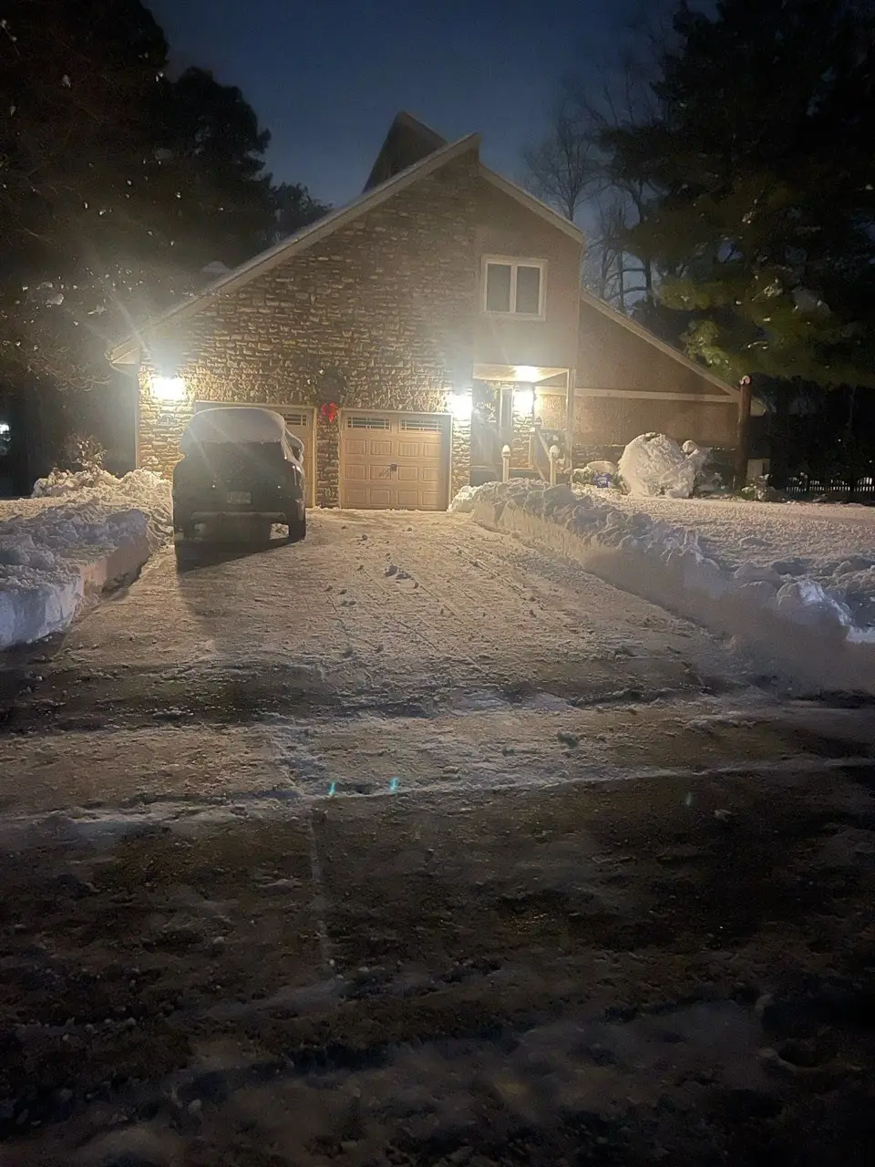 Driveway cleared of snow at night